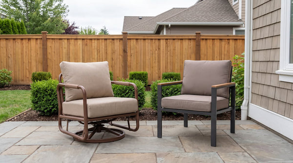 Bronze aluminum swivel chair beside a dark E-coated steel chair on a stone patio, frames compared side by side