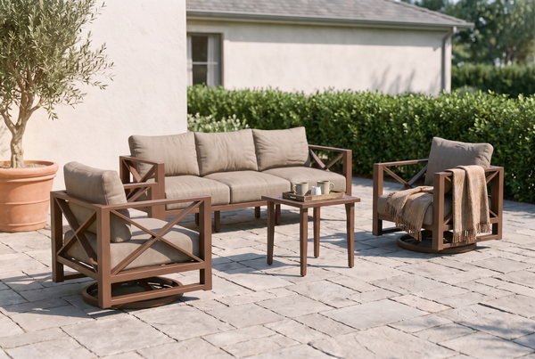 Bronze aluminum patio conversation set with taupe cushions on a stone paver patio, coffee tray and throw blanket styled for a buying guide