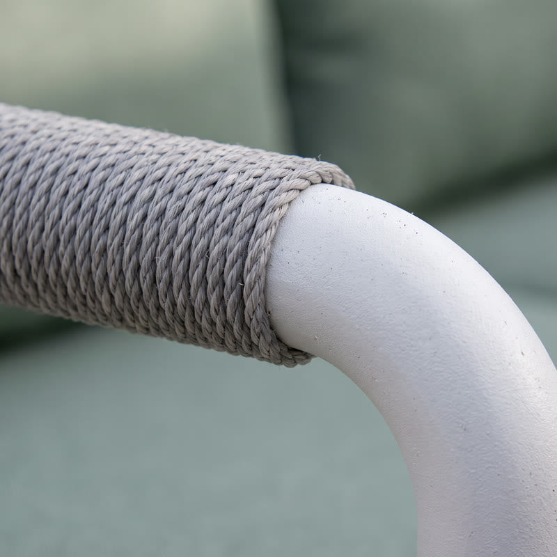 Close-up of a white aluminum patio chair frame and rope-wrapped armrest