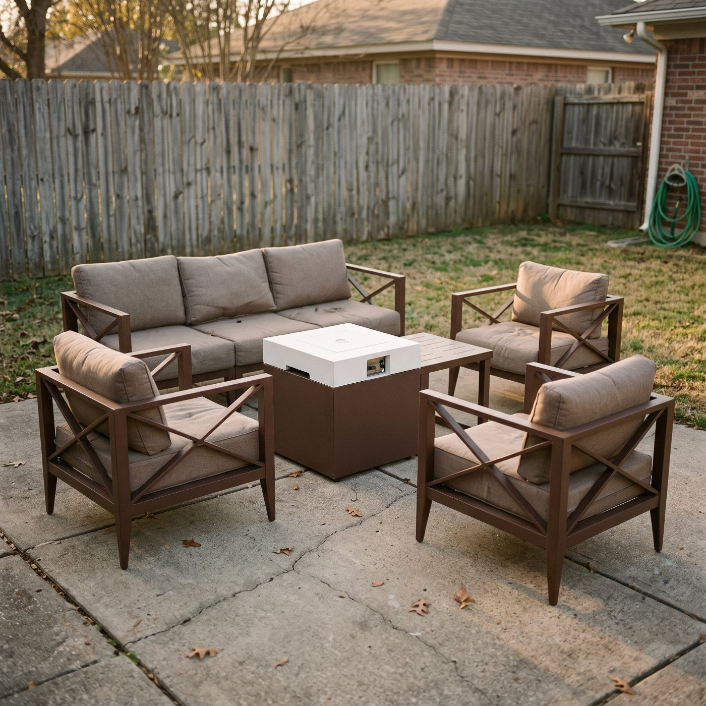 Aluminum conversation set with fire pit table on an ordinary backyard patio
